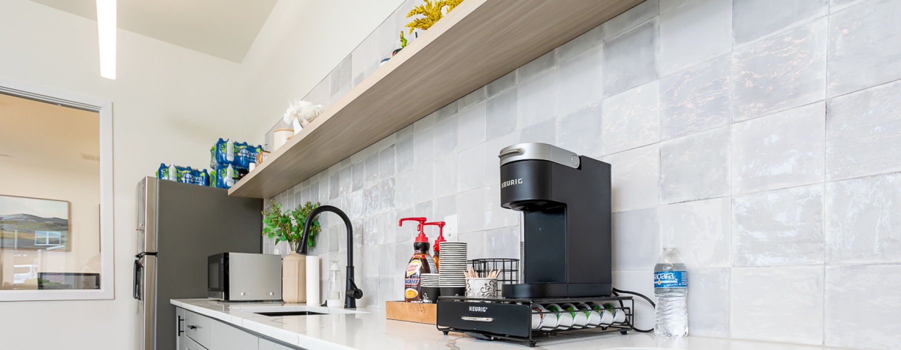 Galley kitchen with Keurig coffee machine and decor