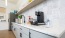 Galley kitchen with Keurig coffee machine and decor